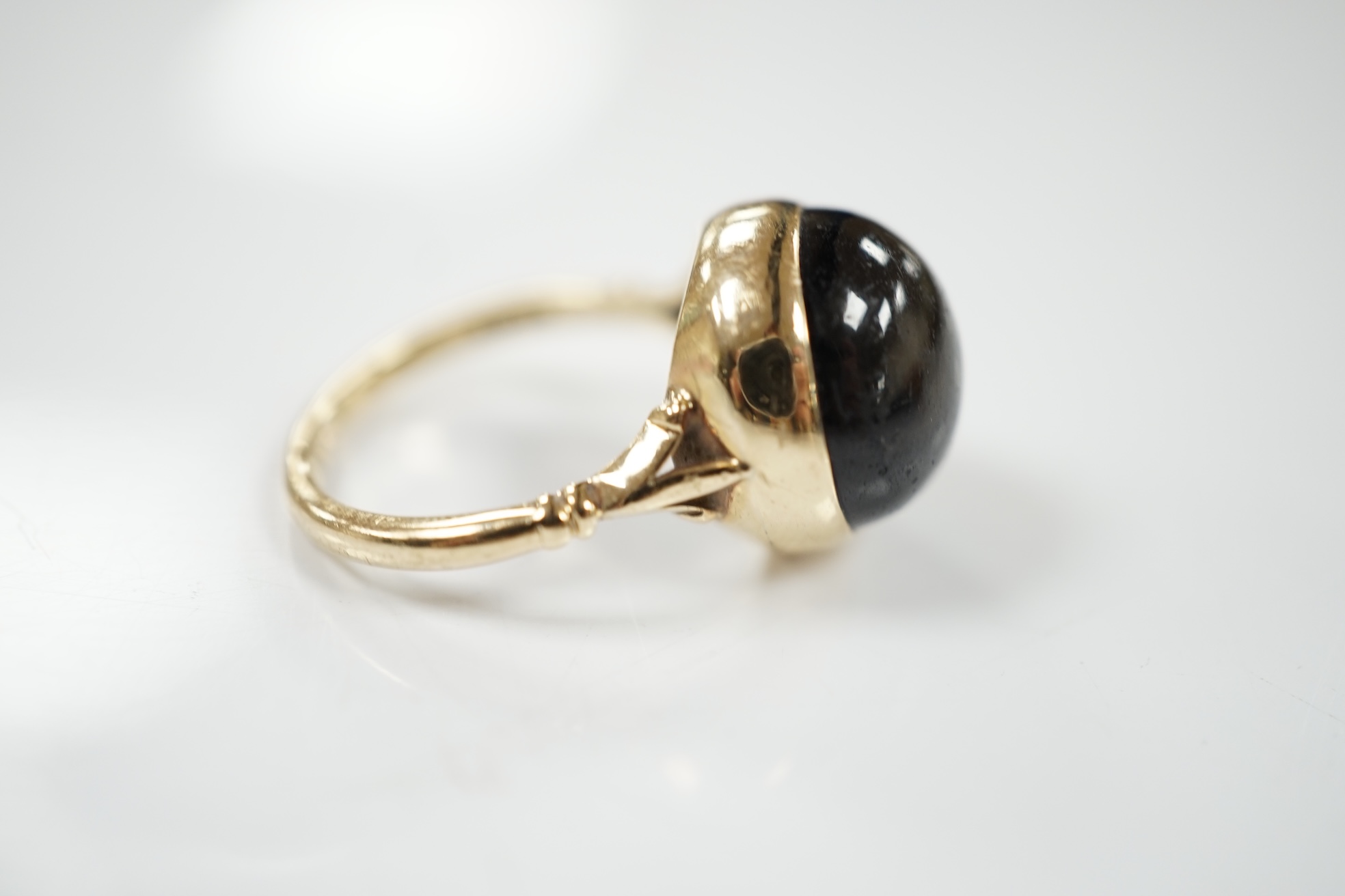 A modern 9ct gold and single stone cabochon black star sapphire set ring, size O/P, gross weight 6.3 grams. Condition - poor to fair